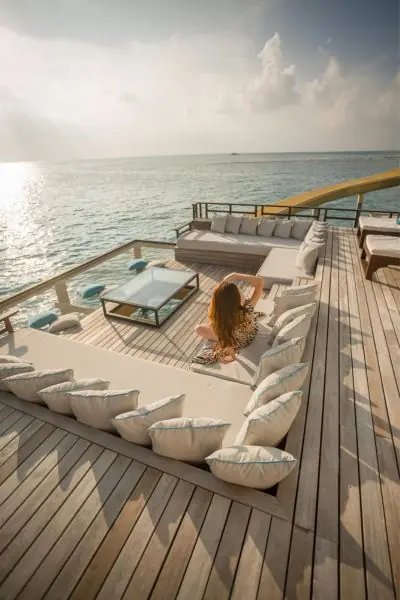 woman enjoying the sun on a multi-level wooden deck