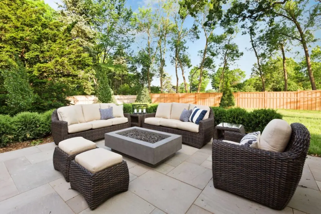 outdoor patio area with comfortable seating around a gas firefit