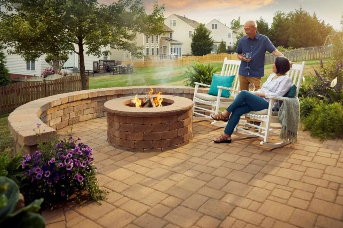 couple having a conversation at outdoor fireplace