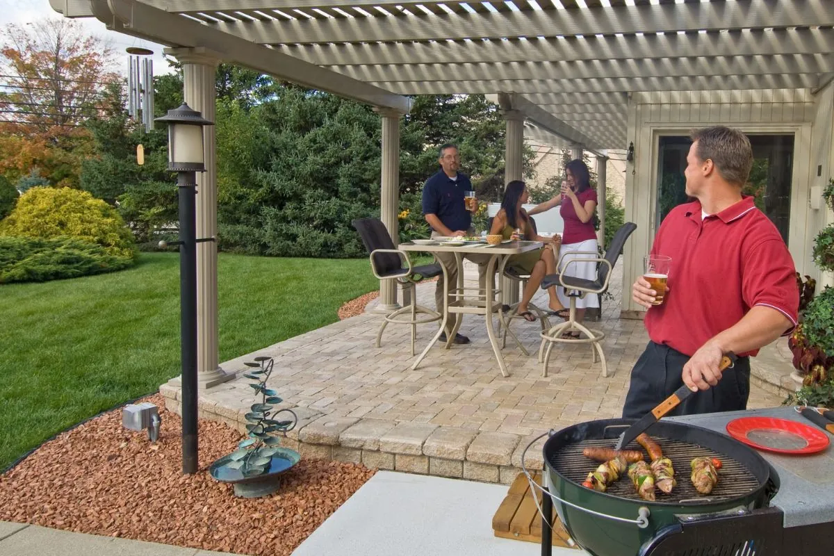 family enjoying weekend at the backyard under pergola