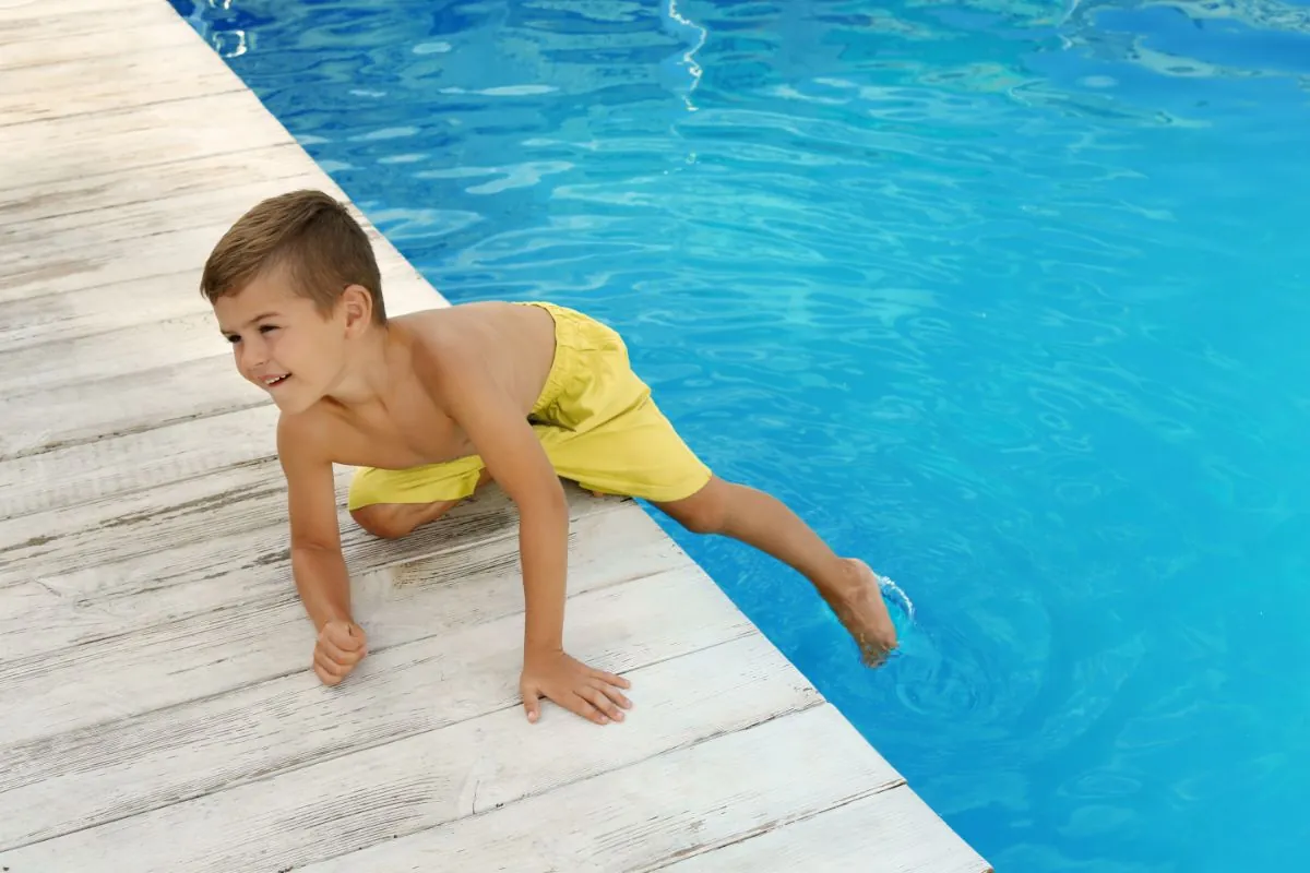 little child near outdoor swimming pool